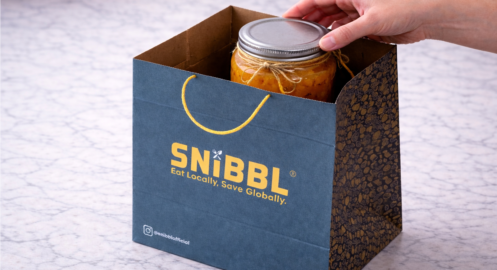Jar of homemade apple jam placed inside a Snibbl bag